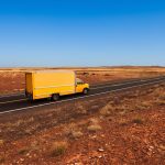 Yellow truck making a long distance move in Tucson Arizona desert