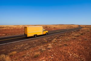 Yellow truck making a long distance move in Tucson Arizona desert